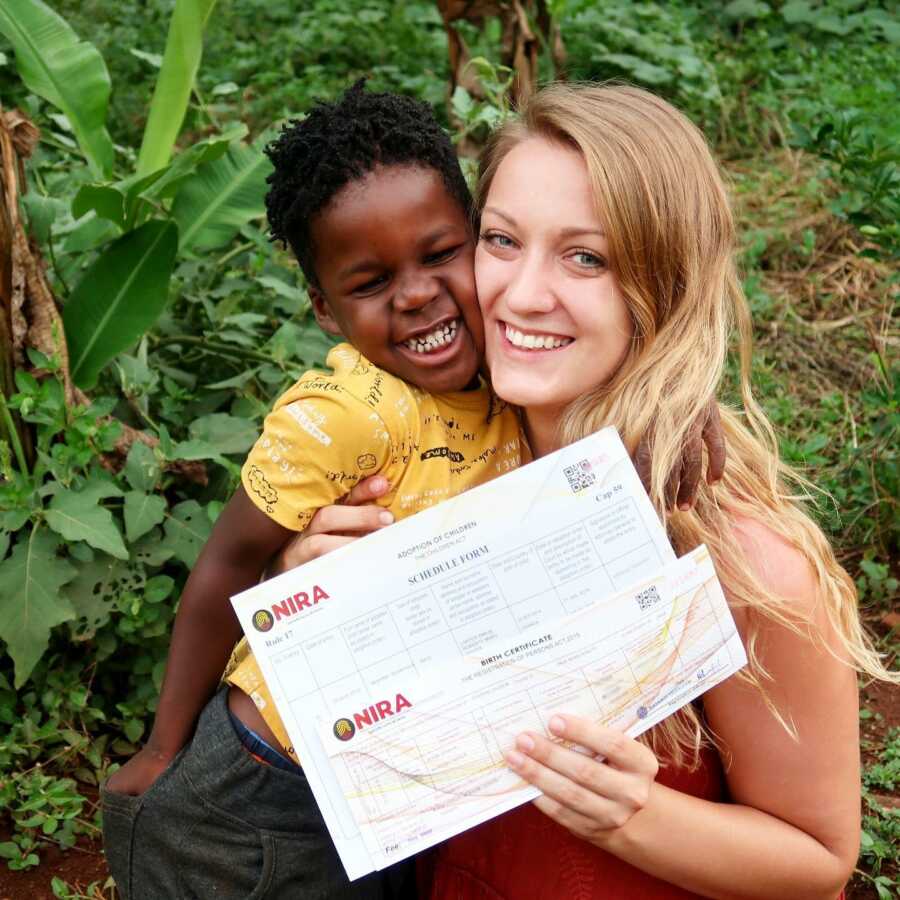 woman happy with her sons papers