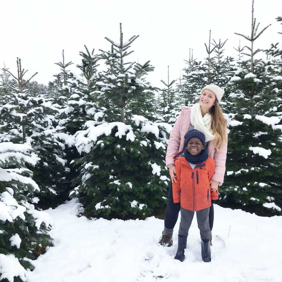 woman taking a picture with her son in the snow