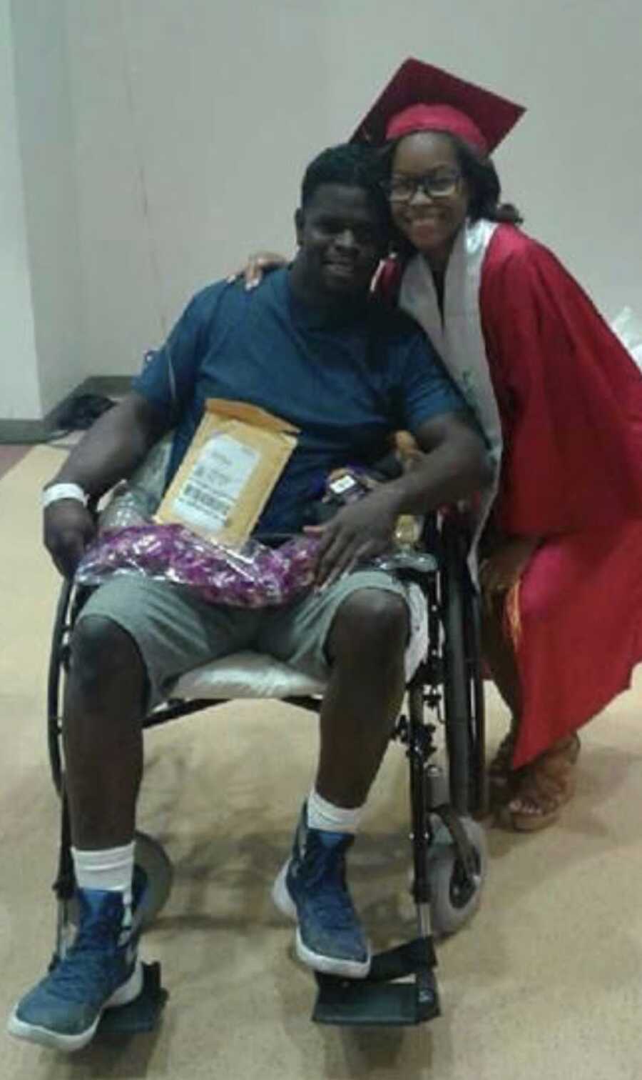 Man in wheelchair smiling with daughter