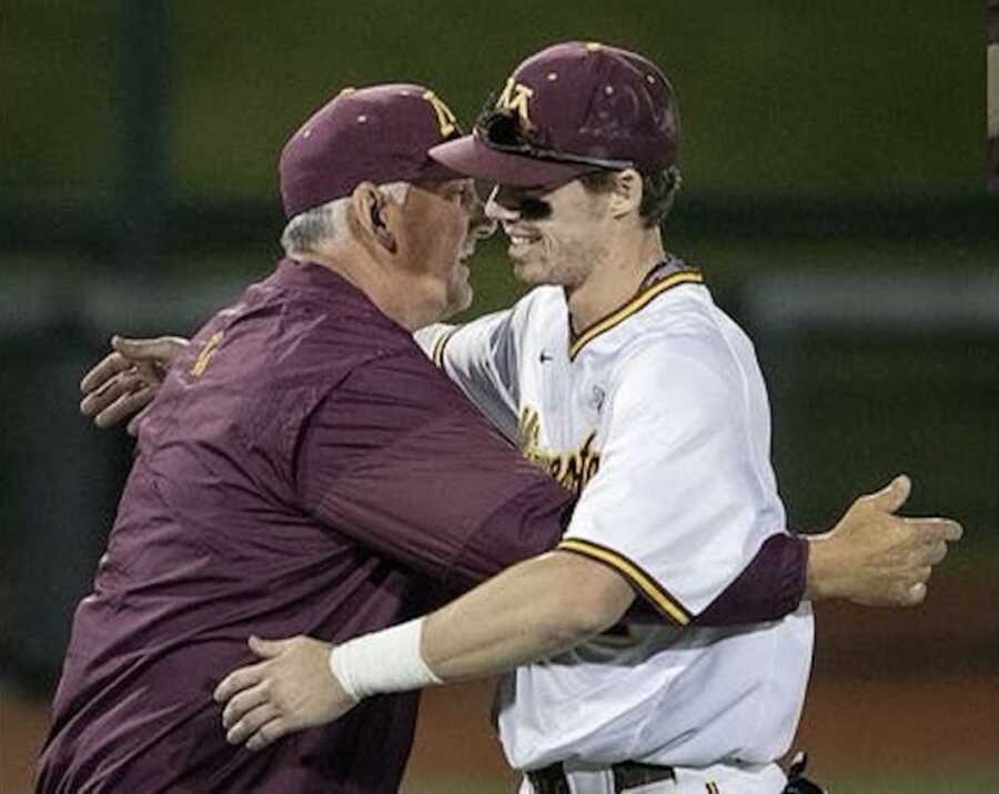 Young adult hugging older man