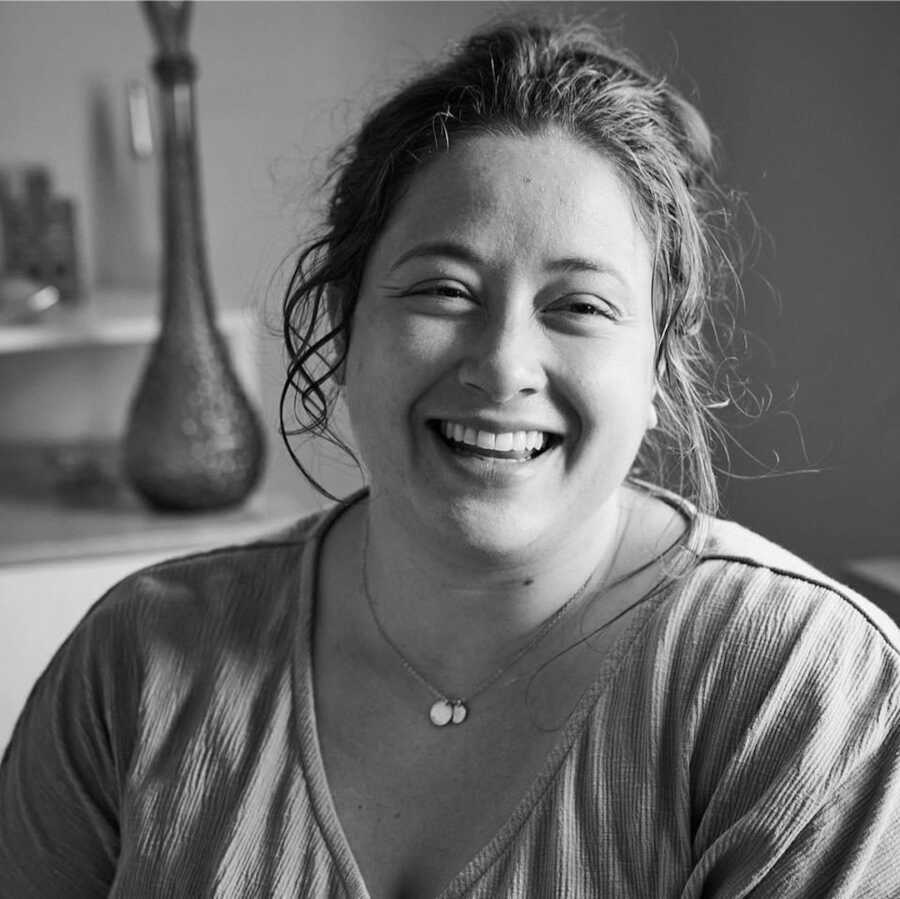 woman smiling in black and white photo