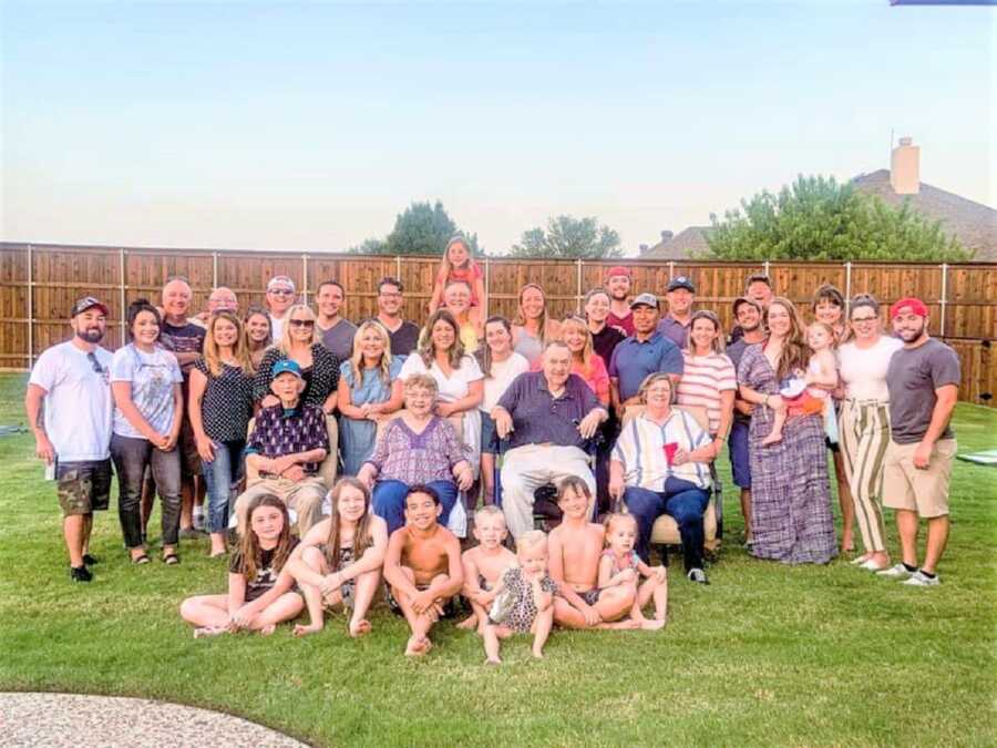 Portrait of multiple generations of a big family in a backyard 