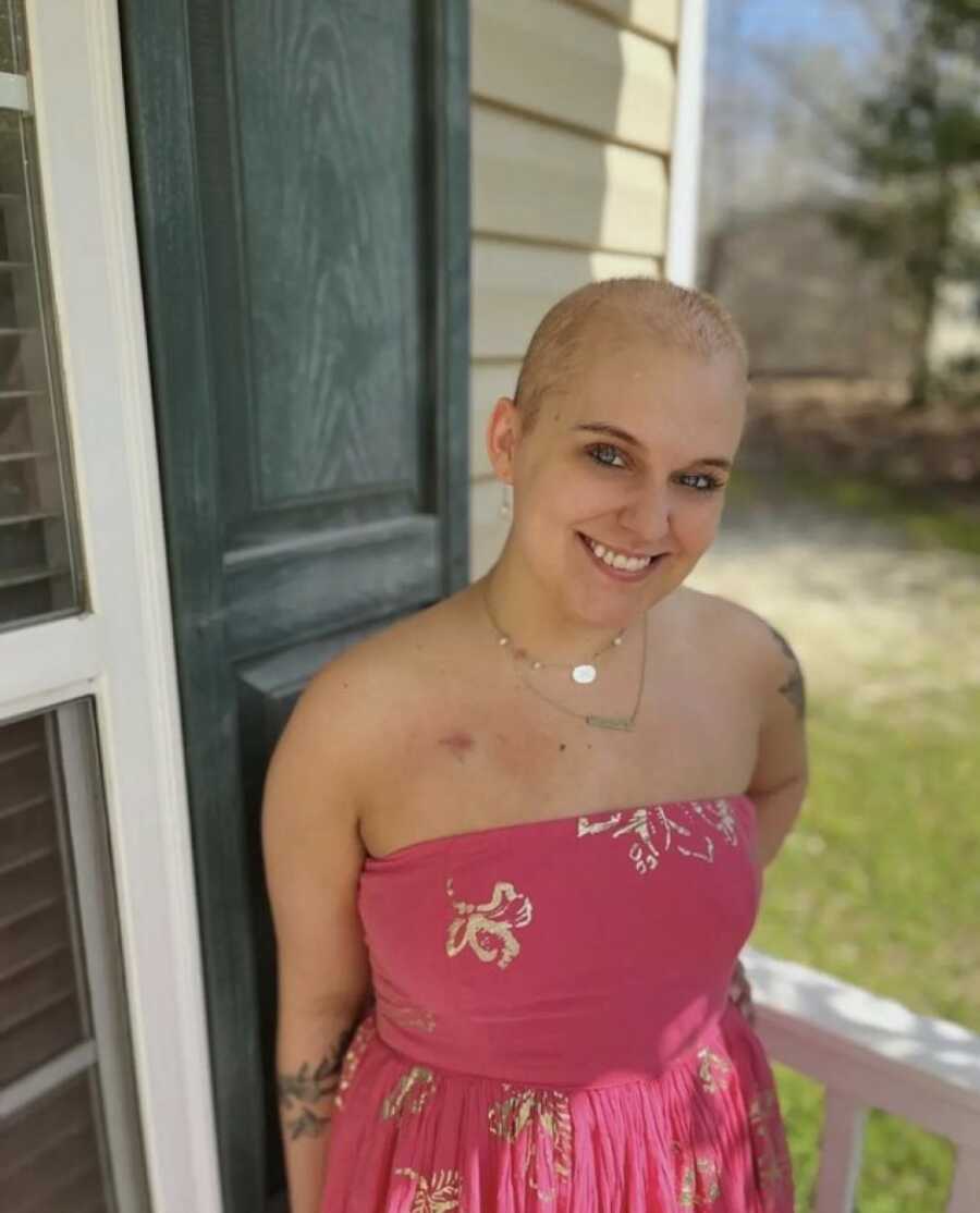 woman with cancer smiling in a sun dress