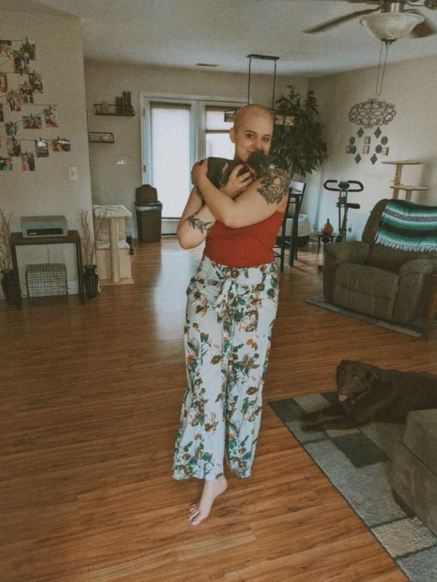 woman with cancer kissing her cat