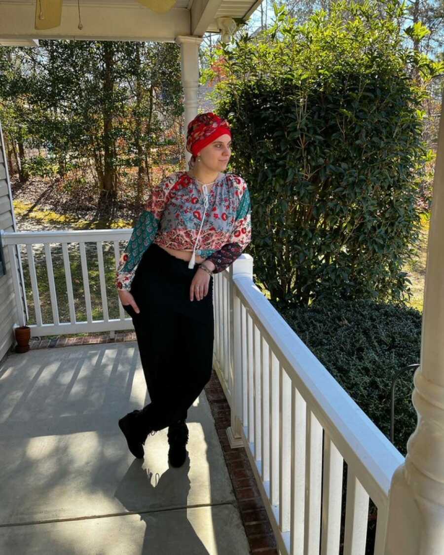 woman with cancer posing on a porch