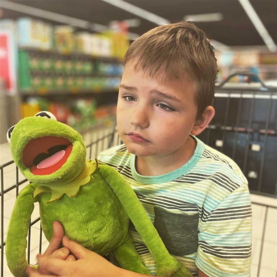 boy with autism holding his kermit the frg