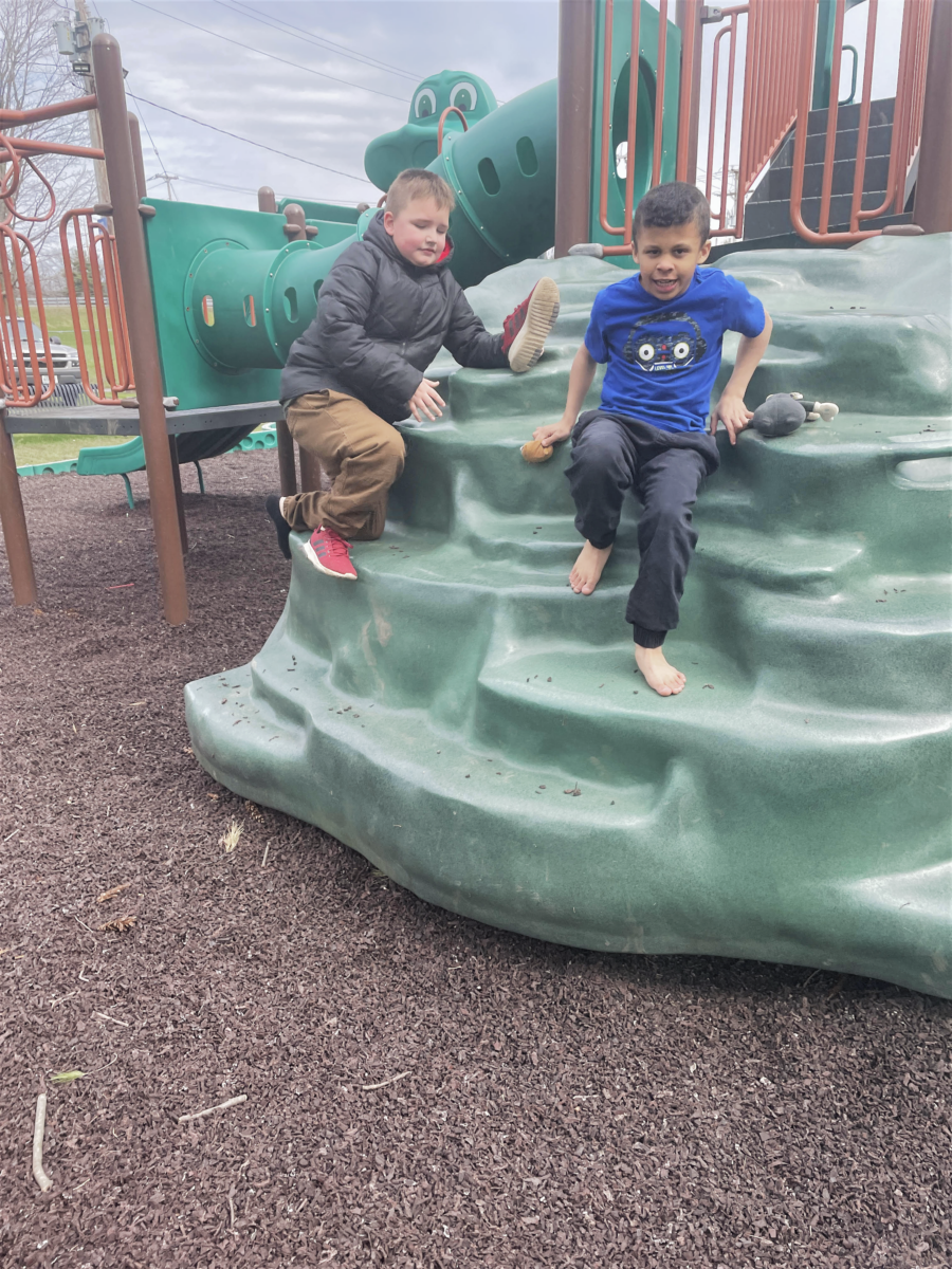 brothers playing together on a jungle gym