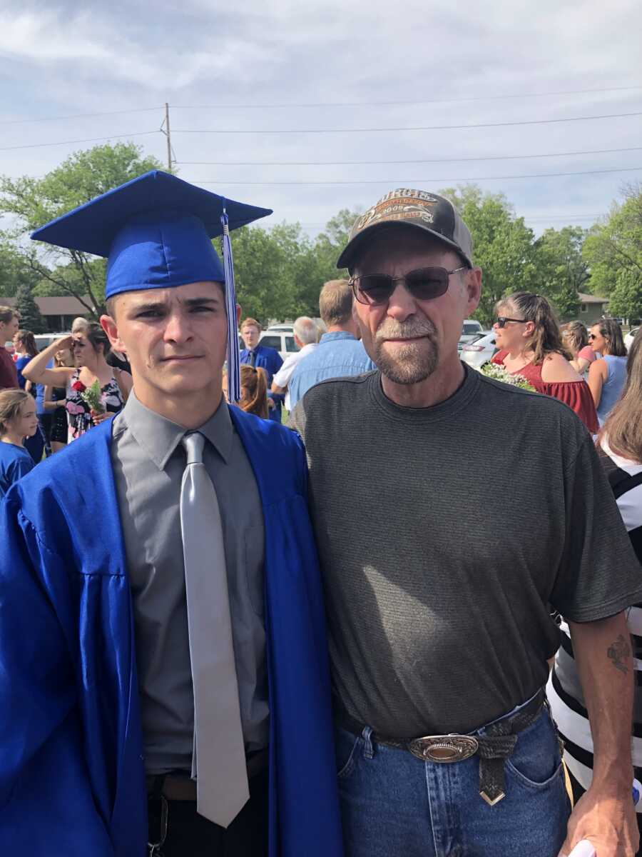 dad with adopted son at his graduation