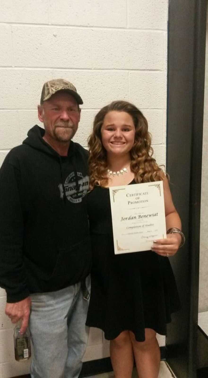 dad with his daughter as she gets a reward