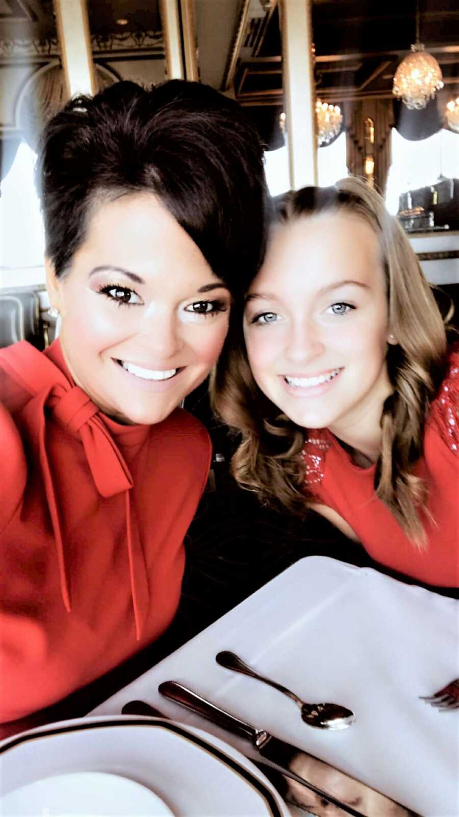 selfie of mother and daughter sitting at a restaurant's table