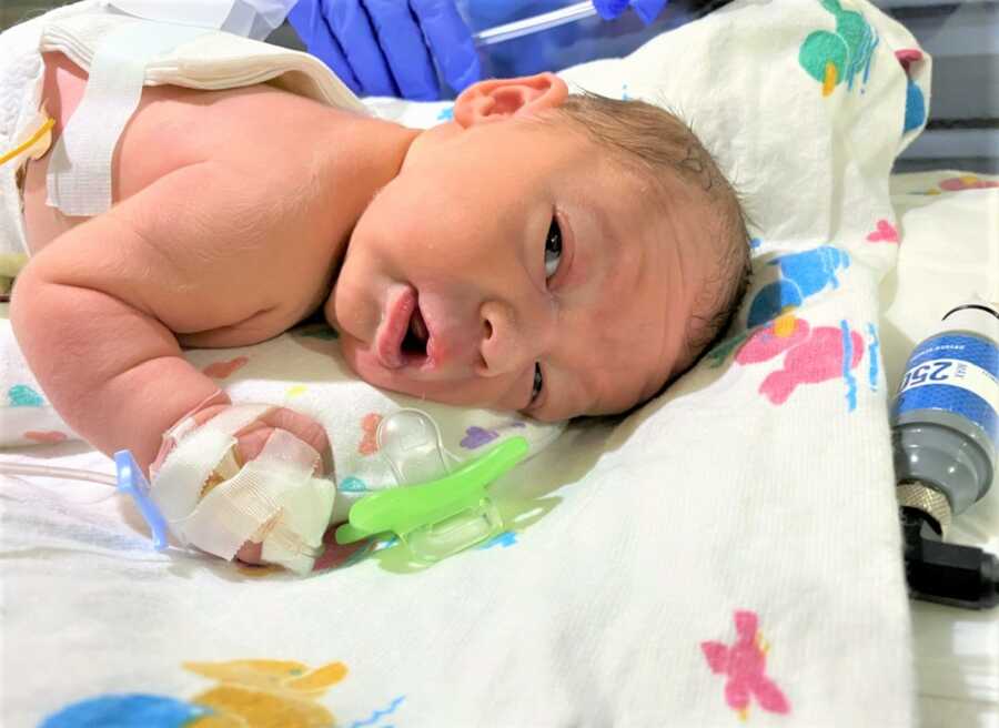 newborn baby baby laying on his belly