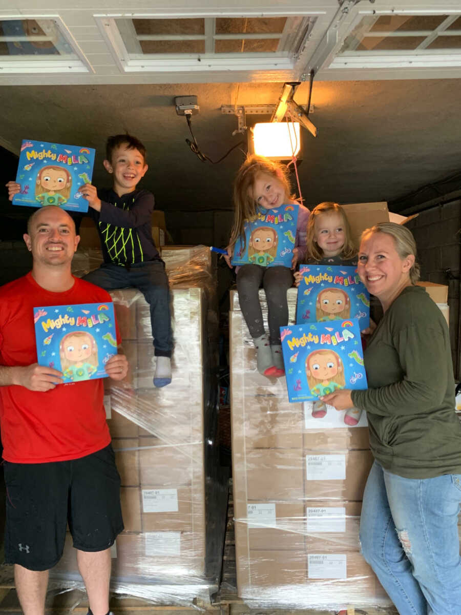 everyone in the family holding up her books