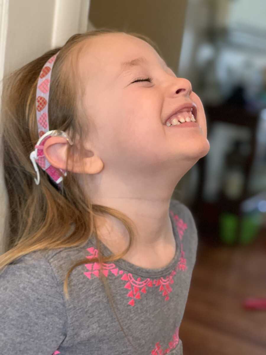 daughter smiling with her cochlear implant