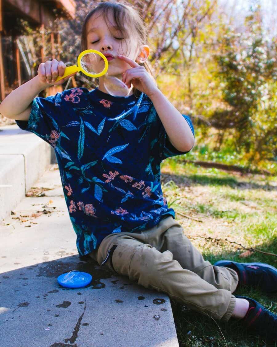 autistic son blowing bubbles