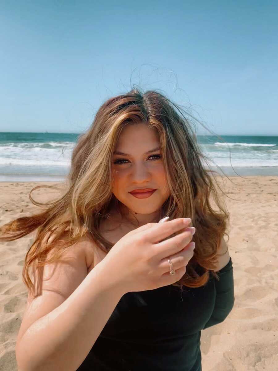 woman without left arm on the beach