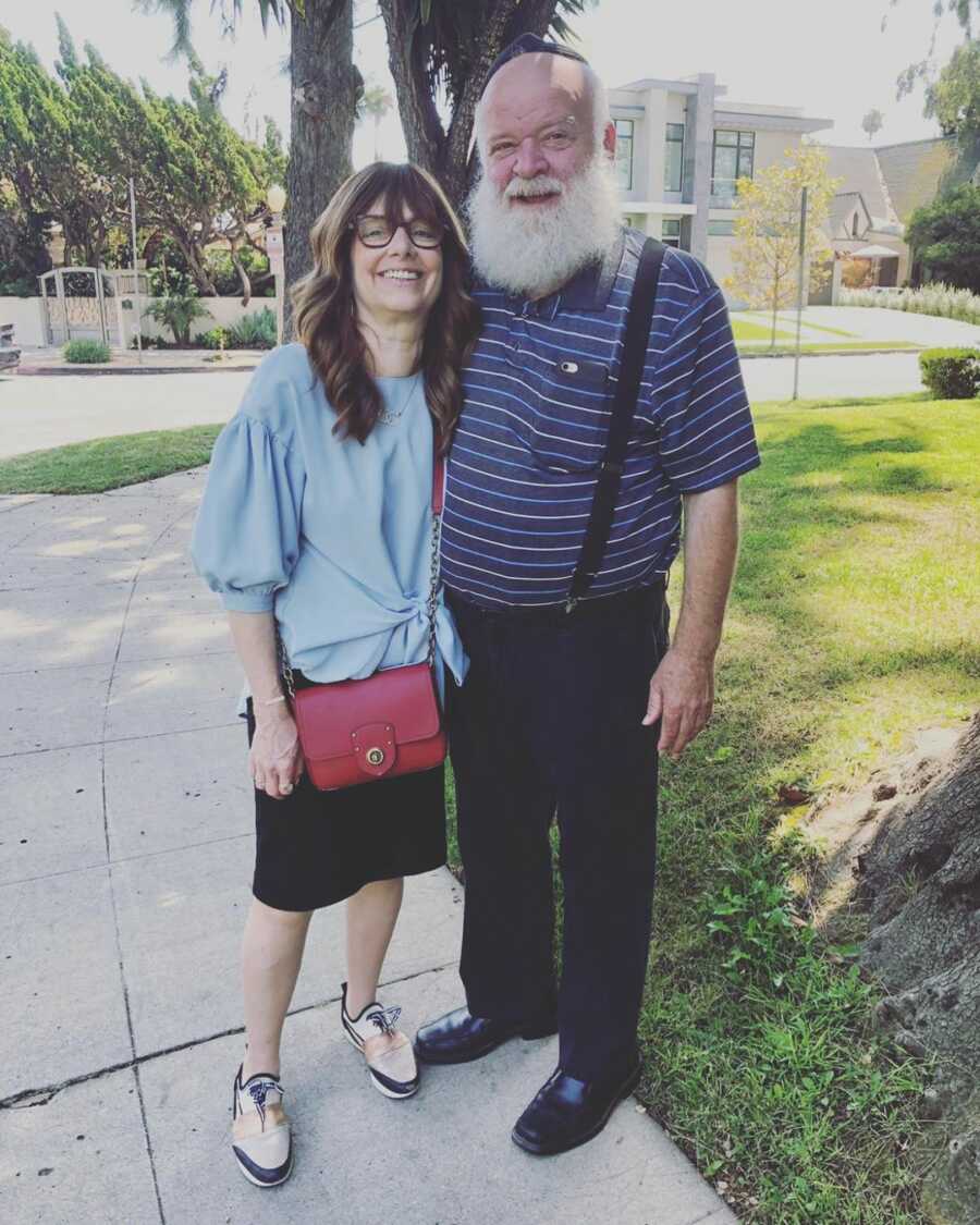 mom and dad smiling and posing together