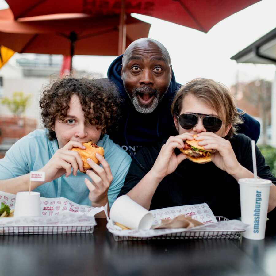 dad being silly while kids eat food