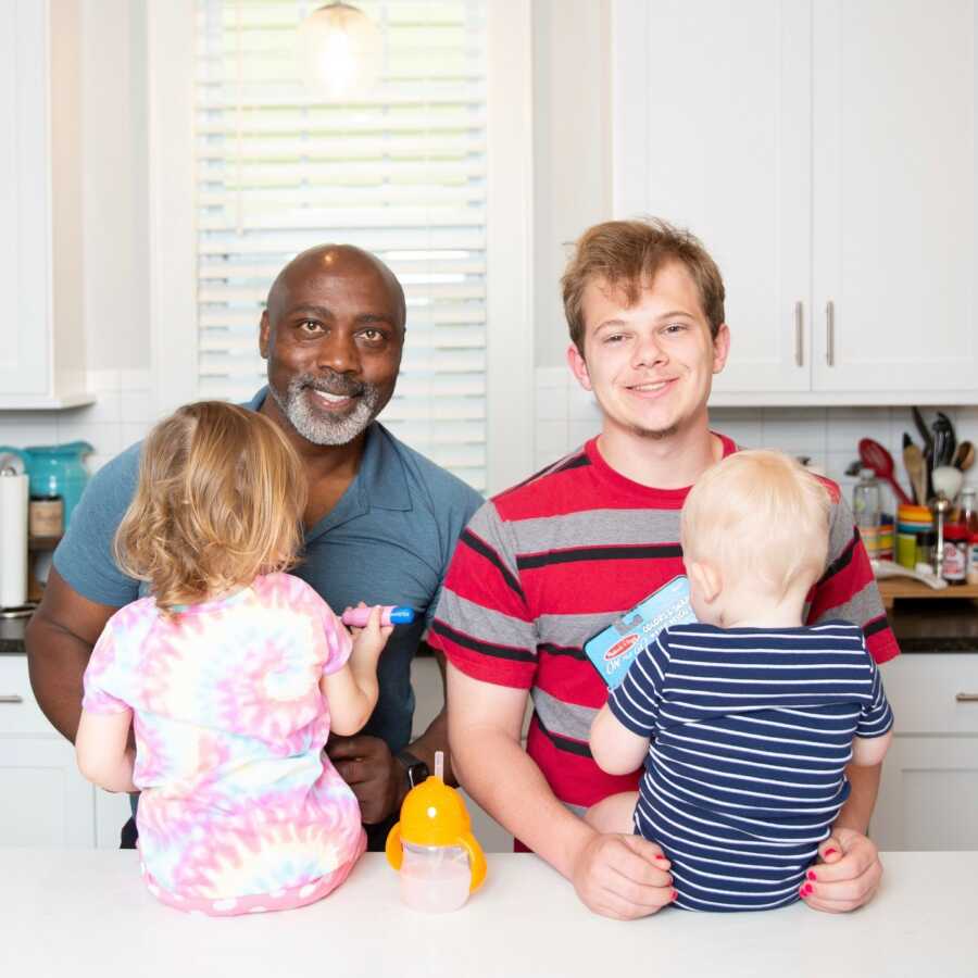 dad son and foster children taking a picture