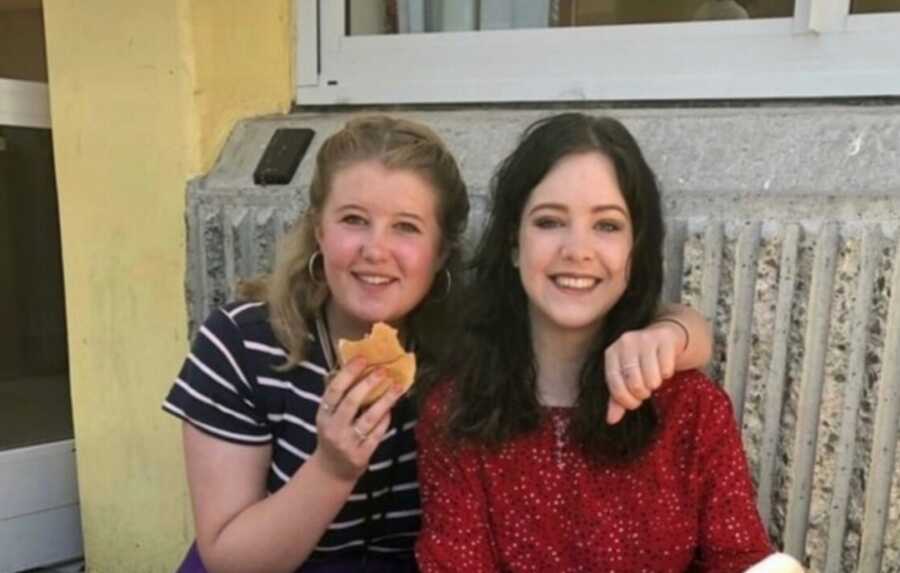 A young woman with her arm around a friend of hers