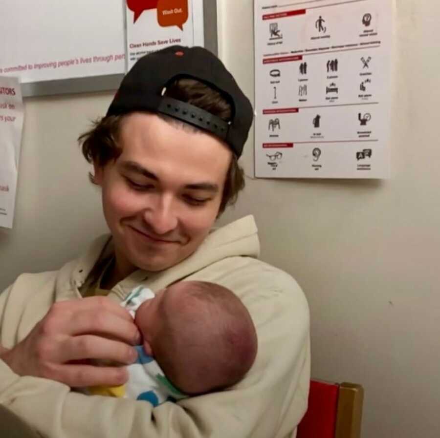 son holding his new born child