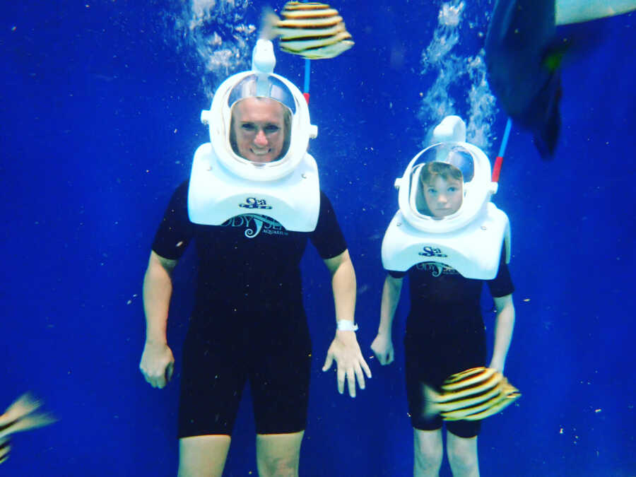 mom and son deep sea diving and taking a picture