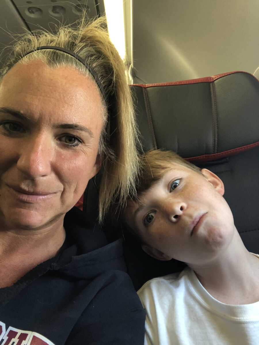 mom and son taking a selfie on a plane