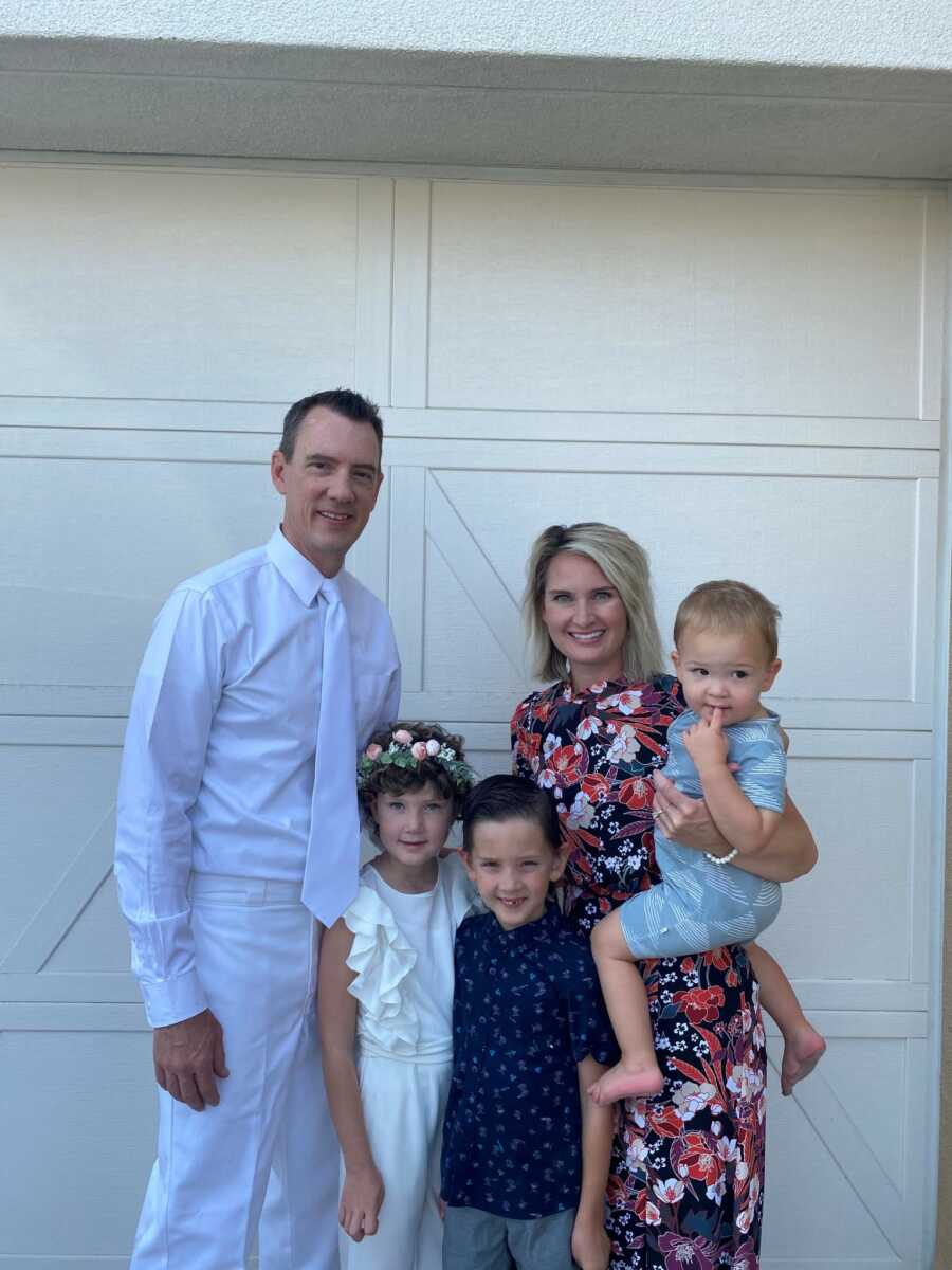 family taking a picture in front of theirhouse