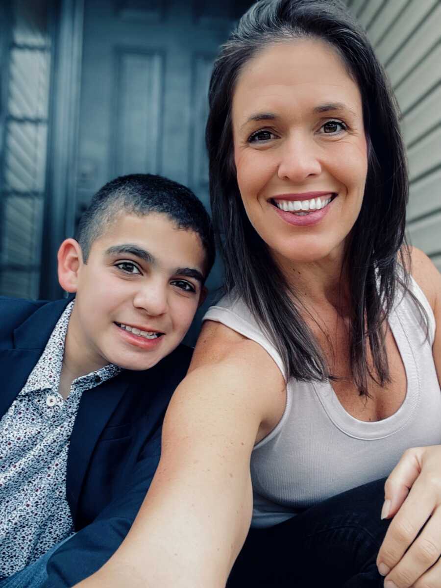 A young boy with autism sits with his therapist