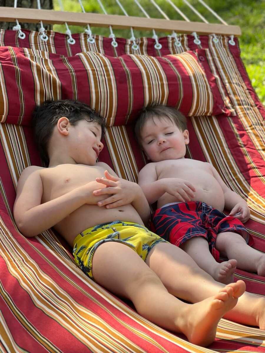 two brothers laying in hammock together 