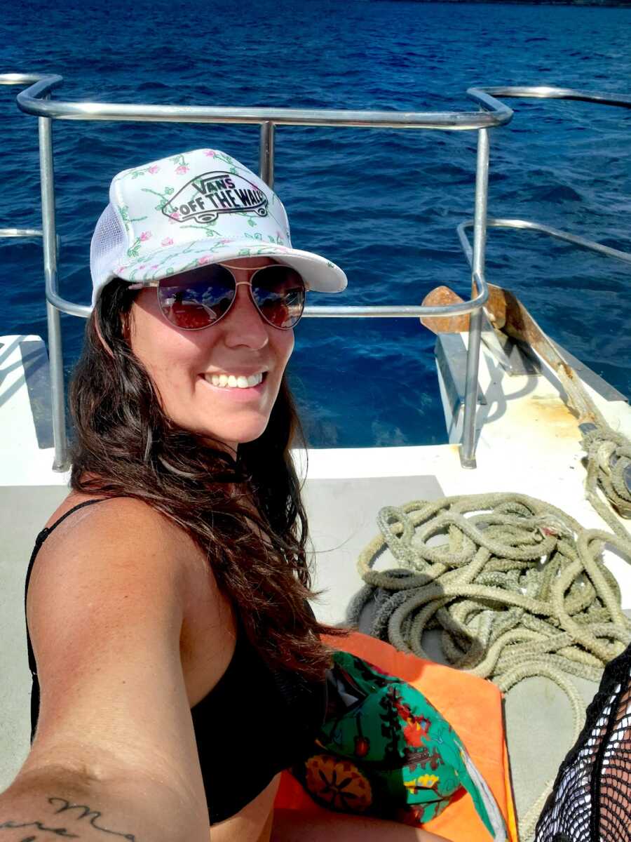 sober woman takes a selfie while on a boat