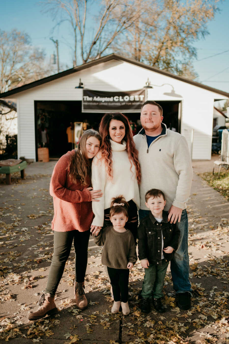 family standing in front of their business, The Adopted Closet