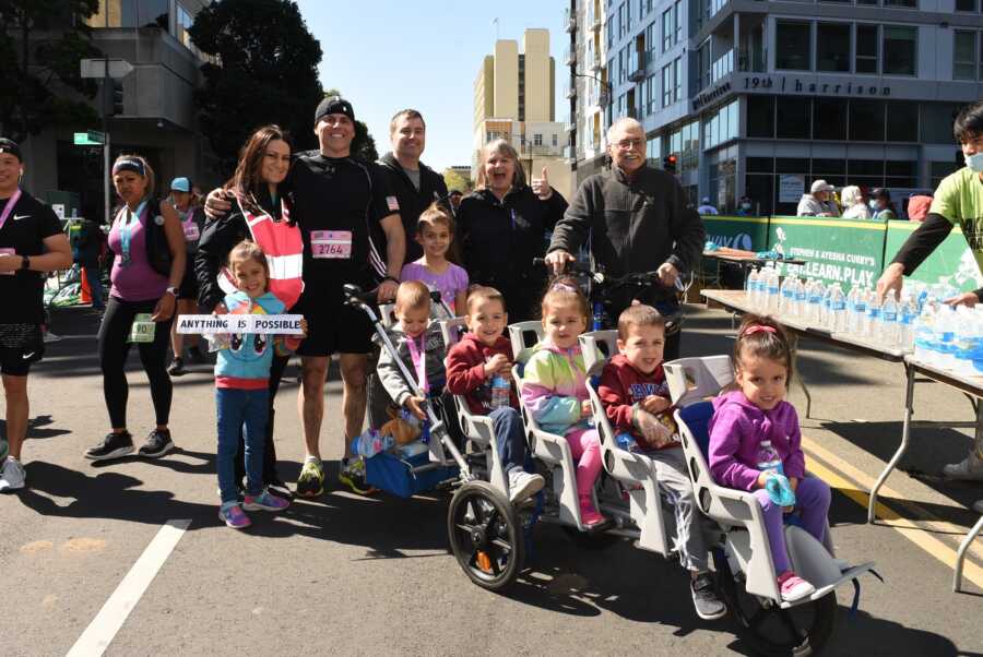 family poses together after dad runs half marathon while pushing their quintuplets