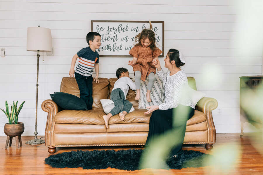 family on couch together laughing 