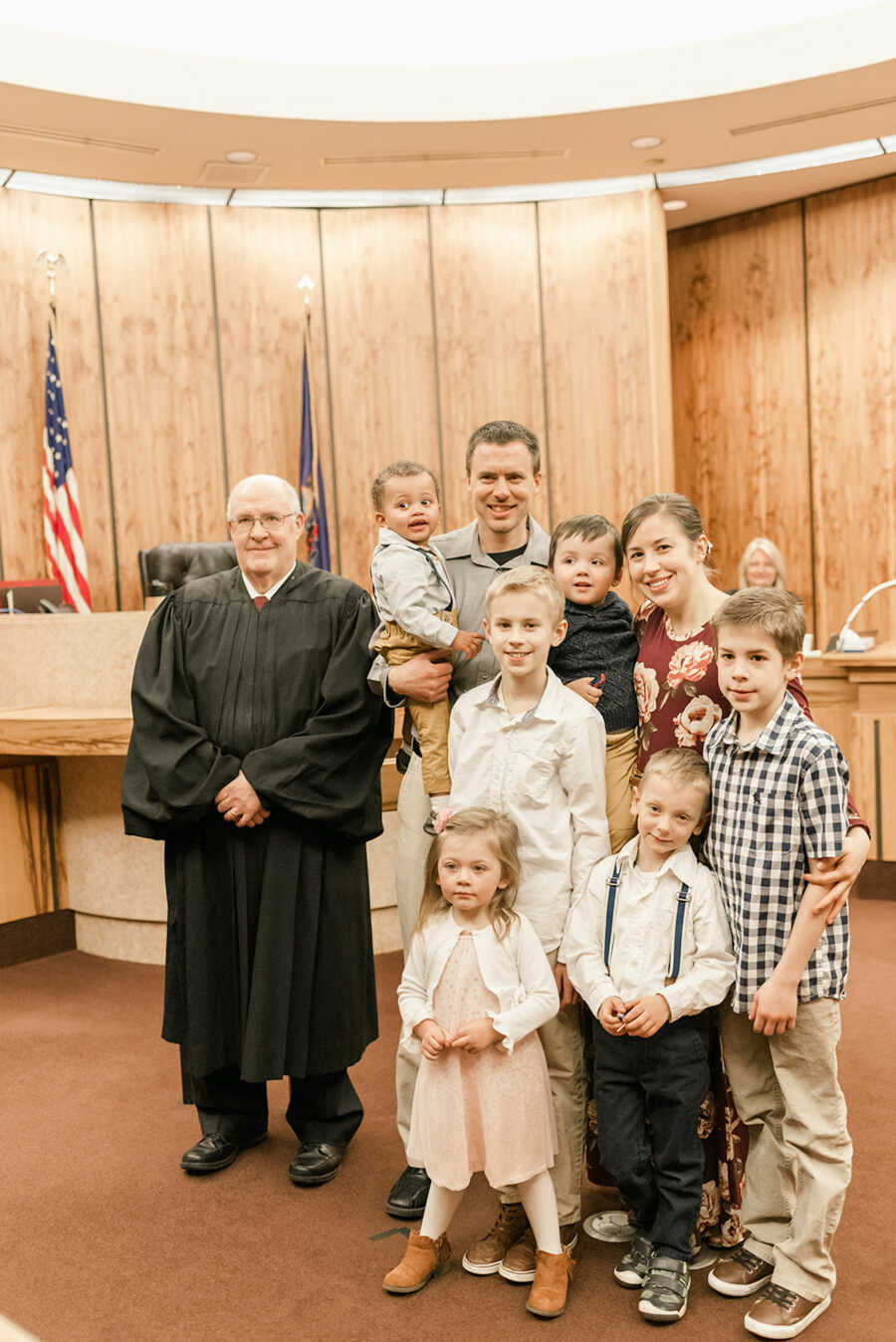 parents with children at courthouse with judge 