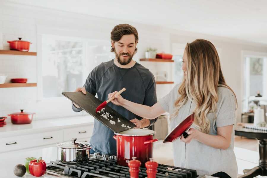 husband and wife cooking in the kitchen 