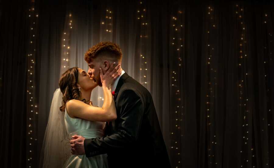 husband and wife kiss on their wedding day