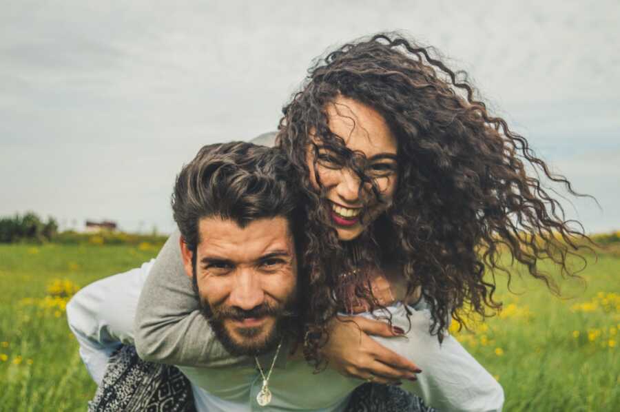 husband holds his wife on his back