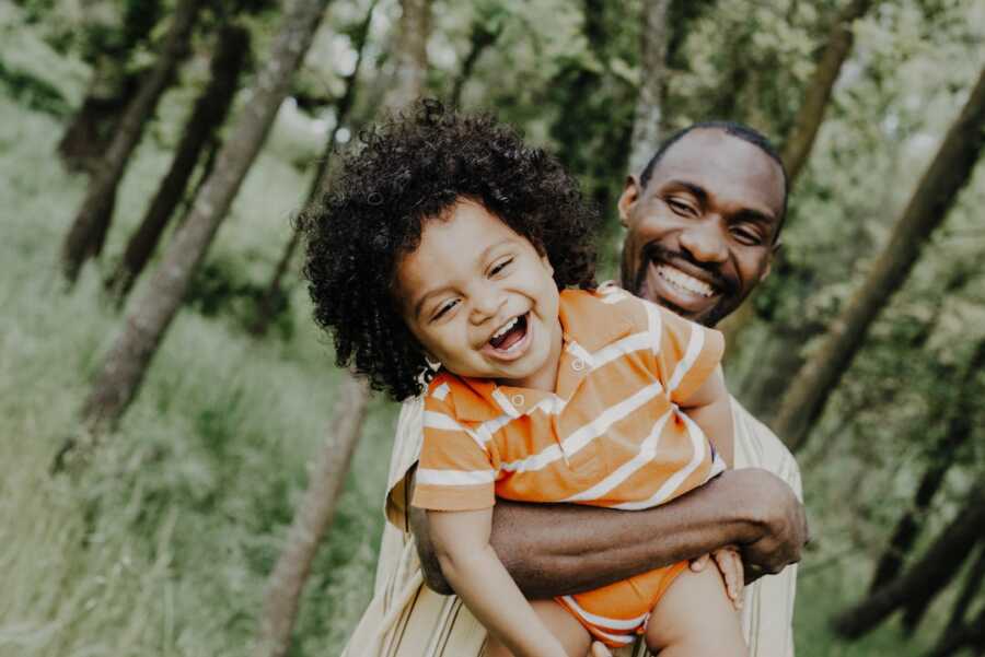 dad holds his son in his arms