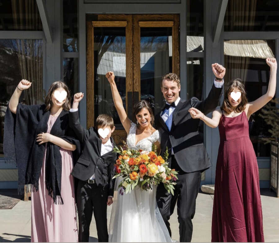 foster parents on their wedding day with three children they are fostering