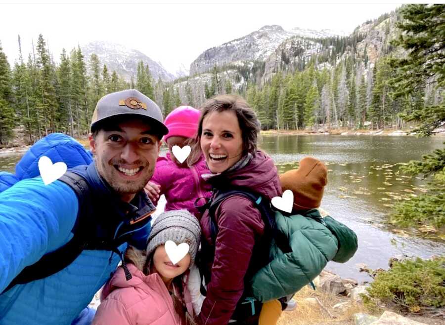 foster parents with four foster children in front of a lake and mountain