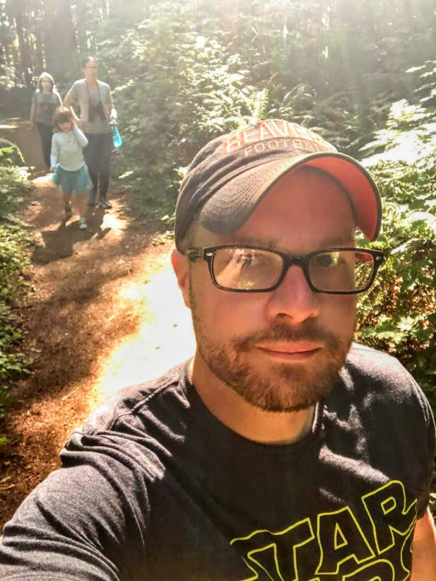 dad on a hike with his family taking a selfie