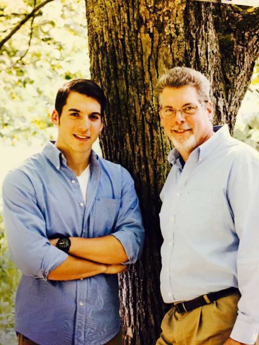 son and dad posing by a tree
