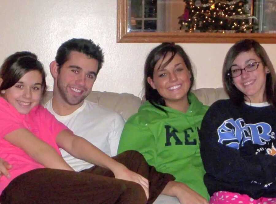Four siblings sit together on a couch