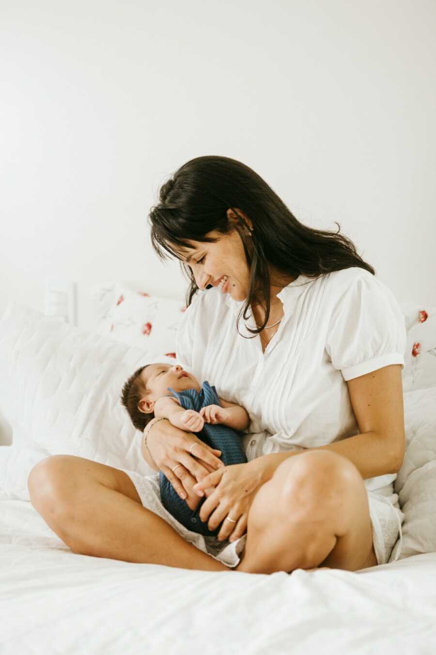 mother holds her baby while she is sleeping