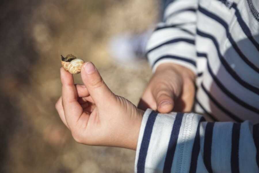 kids inspecting a snail