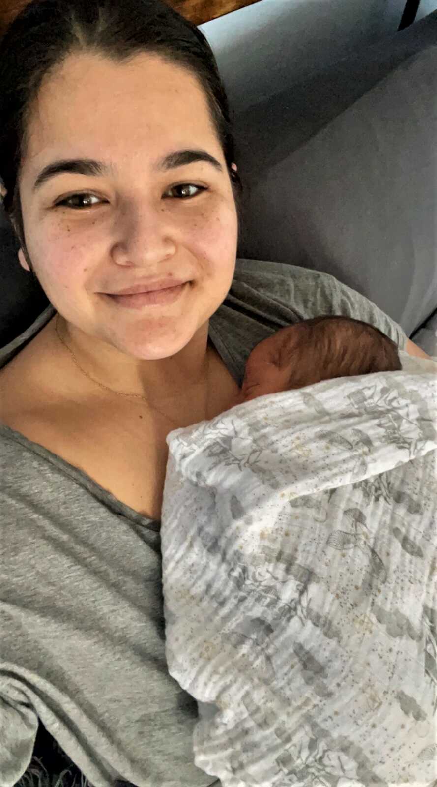 aunt holding her nephew close while he sleeps