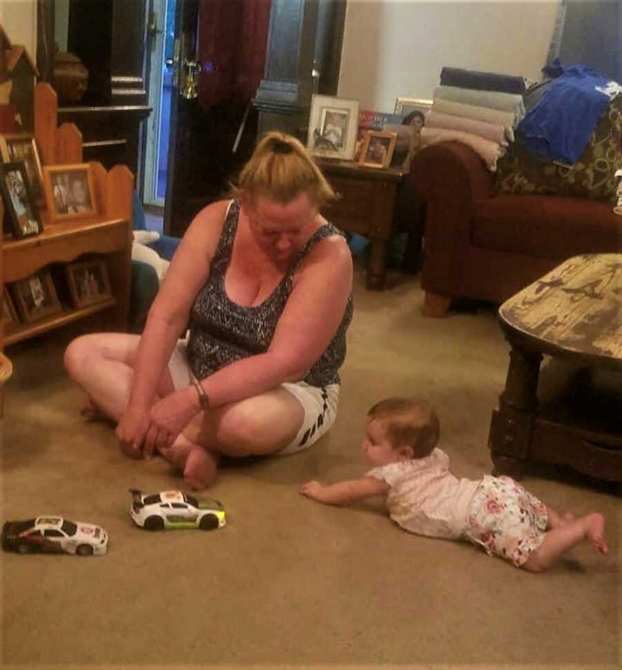 grandma on the ground playing with her granddaughter