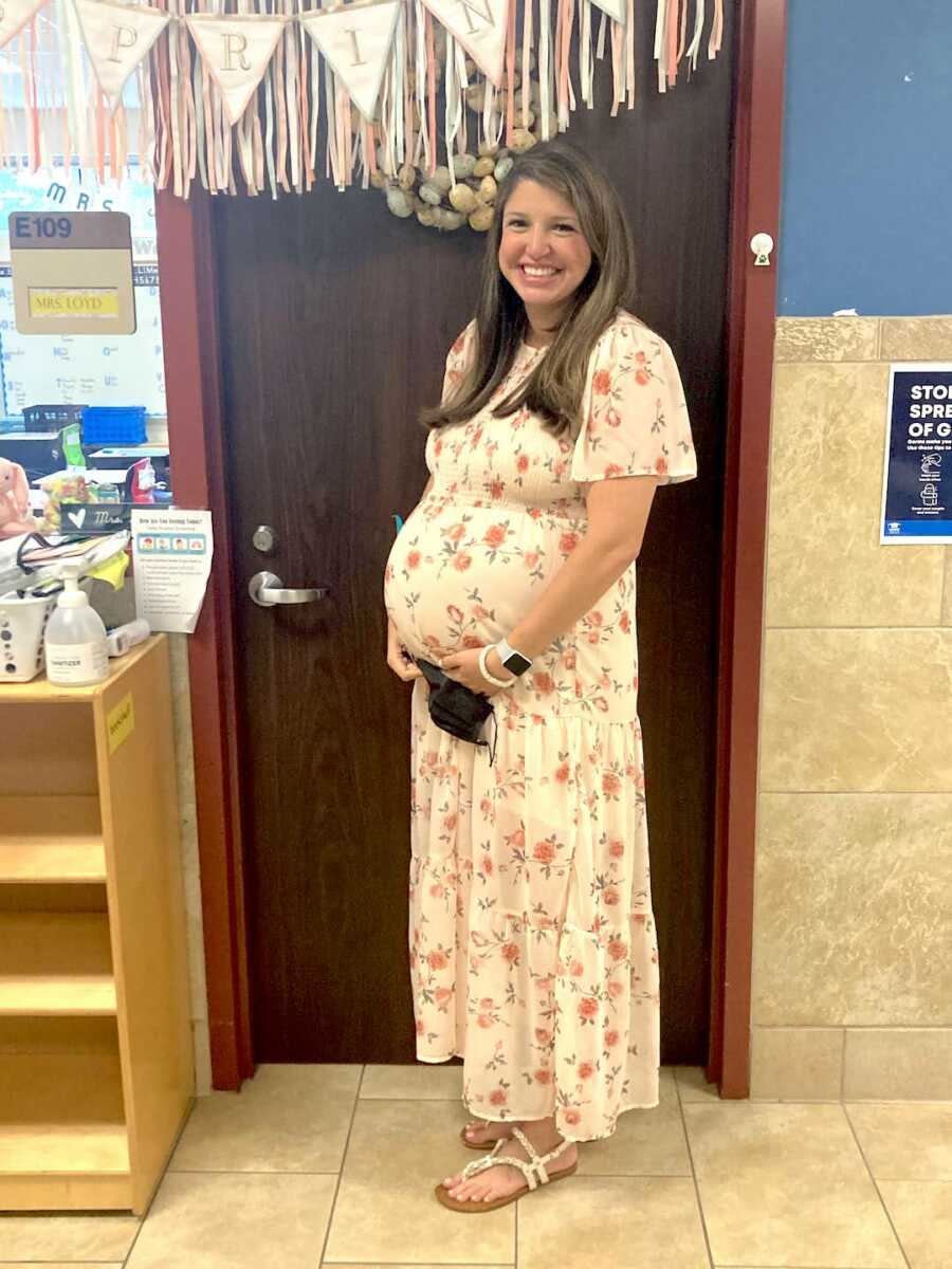 mom standing pregnant at work the day of her induction