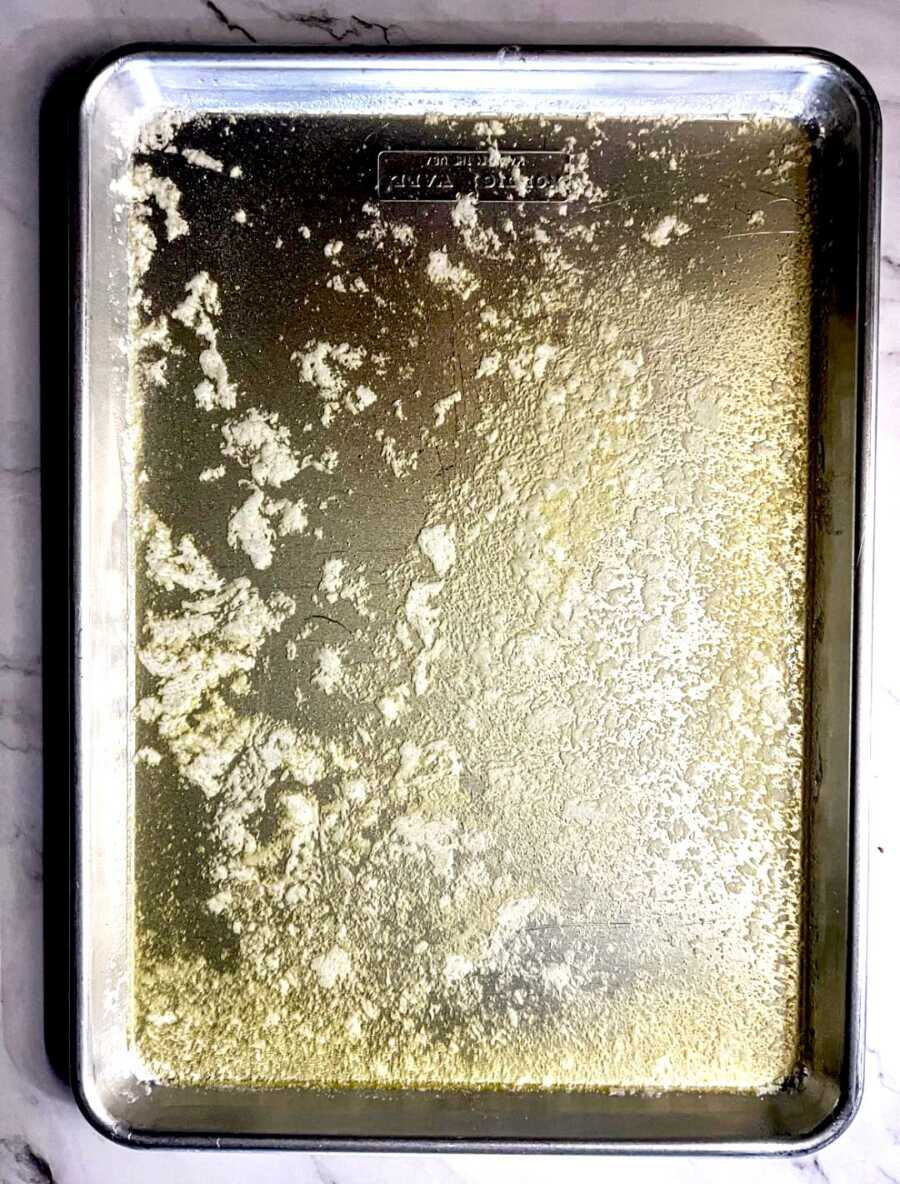 butter melted and covering half sheet pan