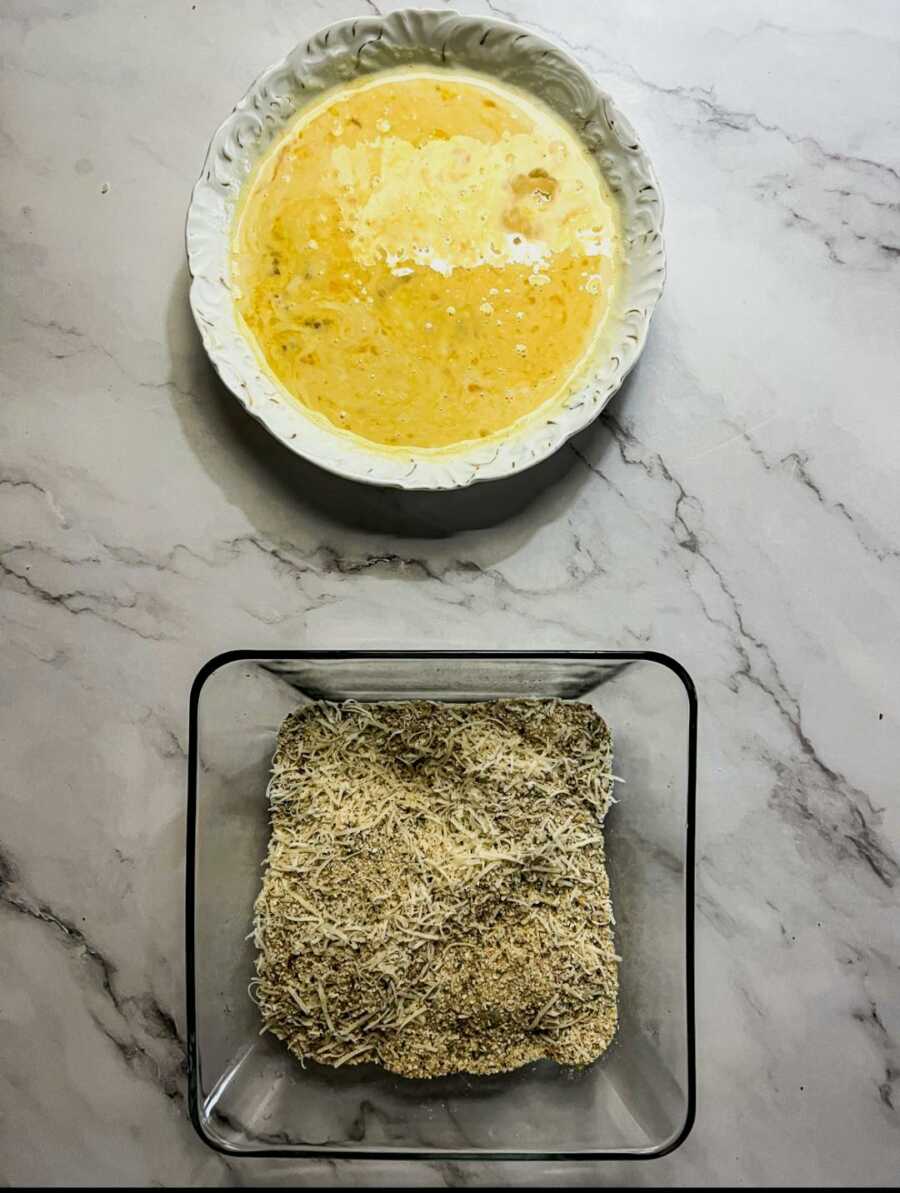 2 bowls one with whisked egg the other with breadcrumb and cheese mixture